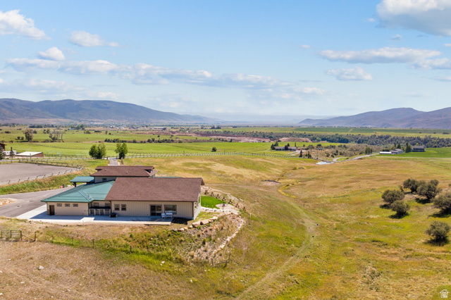 6117 North Rocky Ridge Road Peoa, UT 84061 - Photo 79 of 82 Single-story structure featuring a brown shingle roof and a green metal roof section