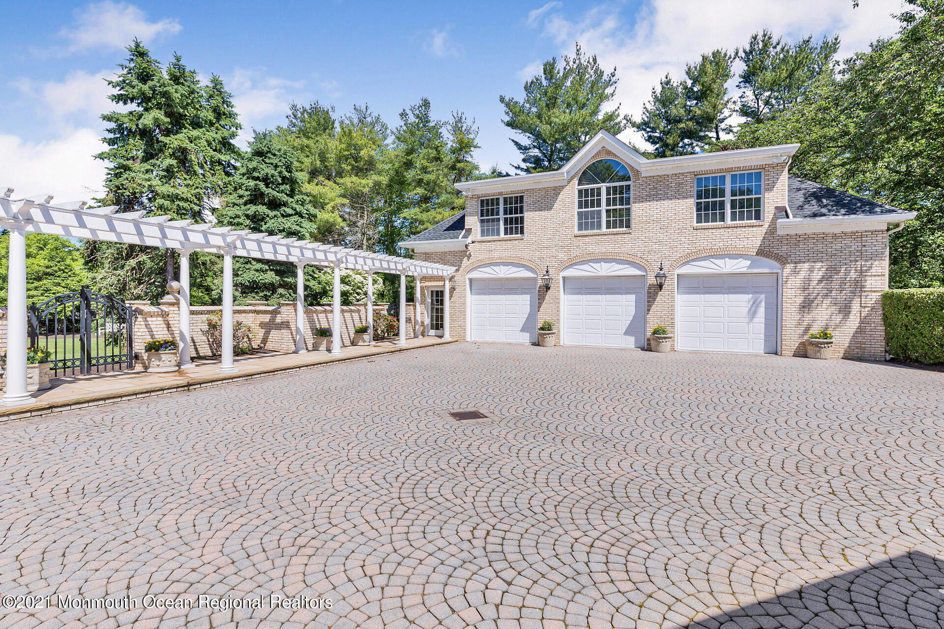 16 A Buttonwood Lane Rumson, NJ 07760 - Photo 5 of 80 a front view of a house with a yard and potted plants