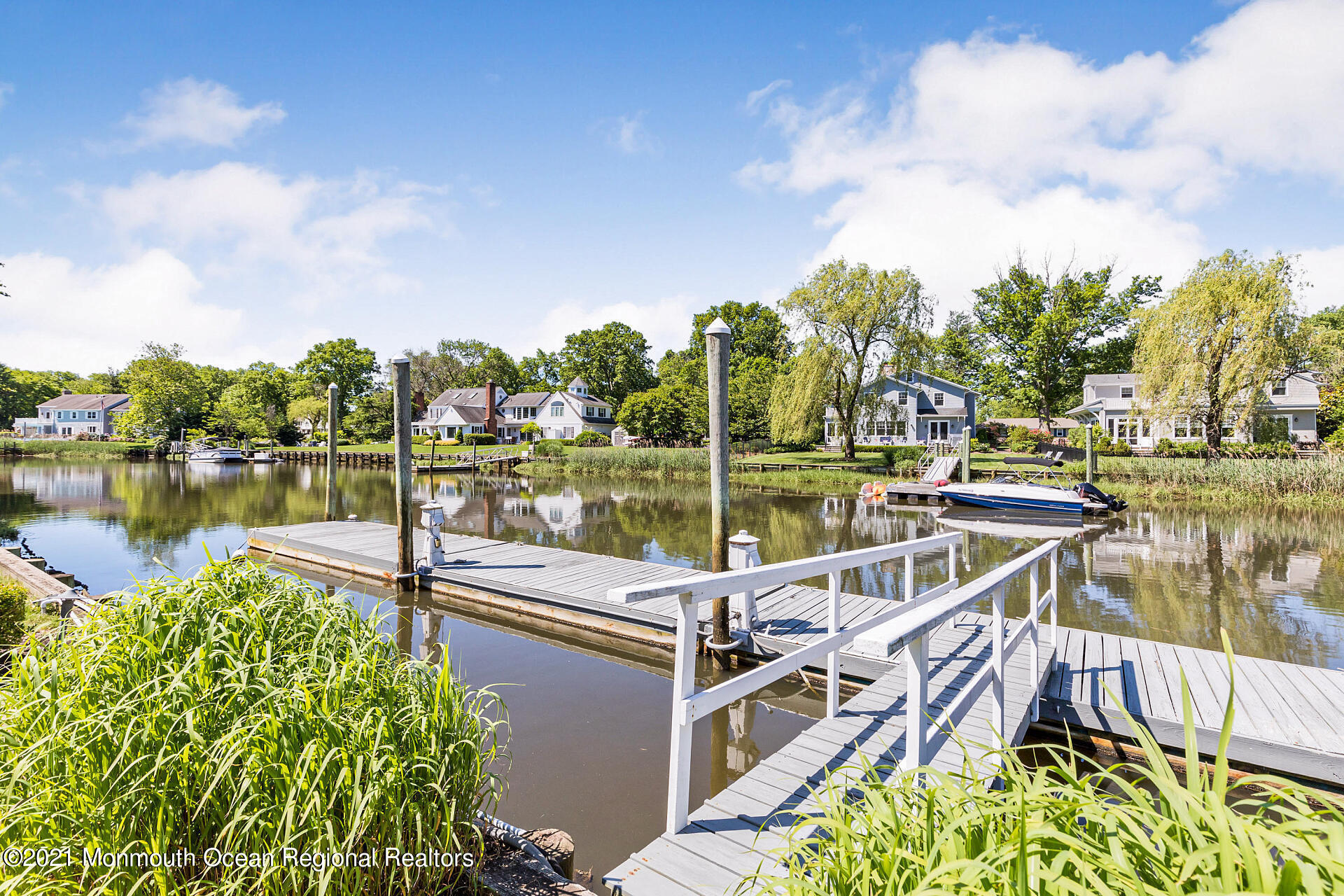 16 A Buttonwood Lane Rumson, NJ 07760 - Photo 66 of 80 a view of a lake with couches in the patio