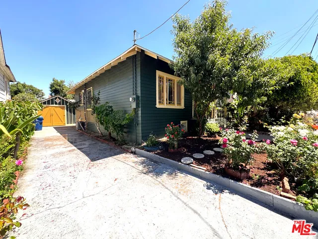 a bunch of flowers in front of a house
