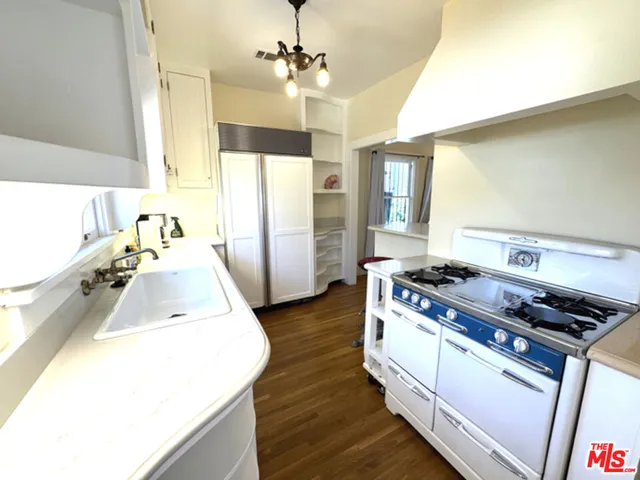 a kitchen with a sink and wooden cabinets