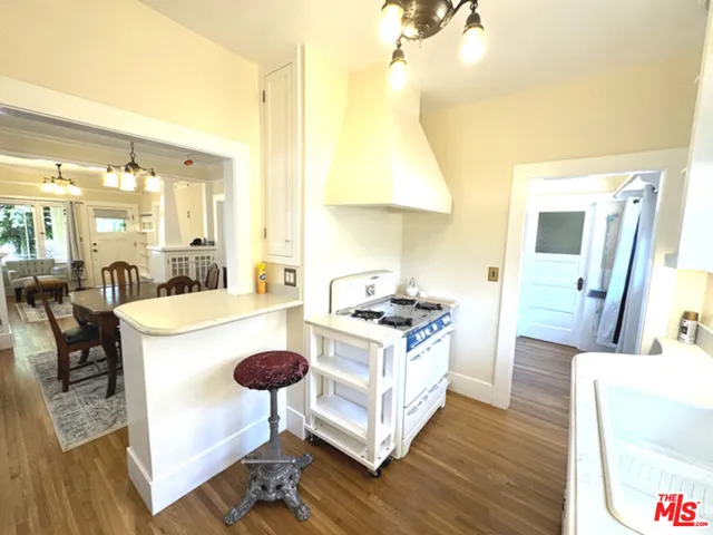 a bedroom with a bed a chair a lamp and the potted plant