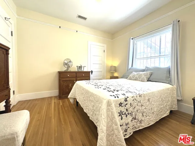 a view of a hallway with wooden floor and windows