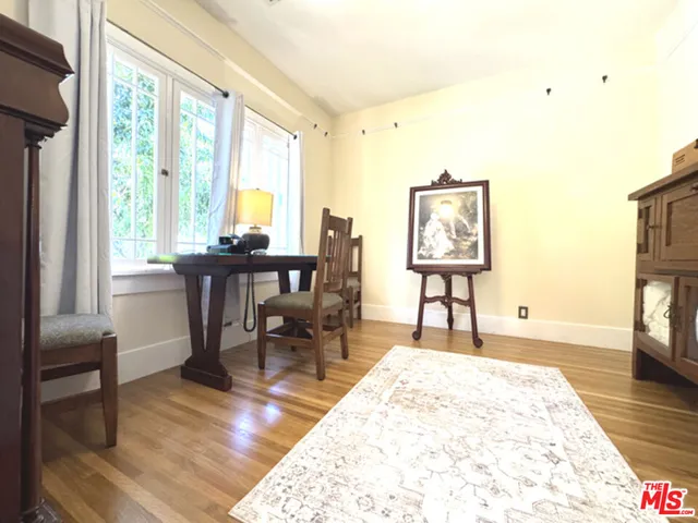 a view of a dining room with furniture a chandelier and wooden floor