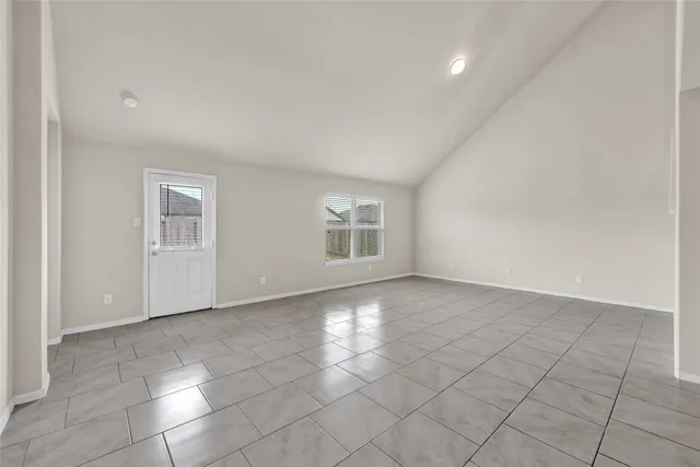 a view of an empty room with glass door