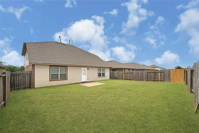 a view of house with yard and entertaining space