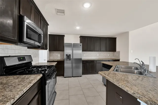 a kitchen with a stove microwave and refrigerator
