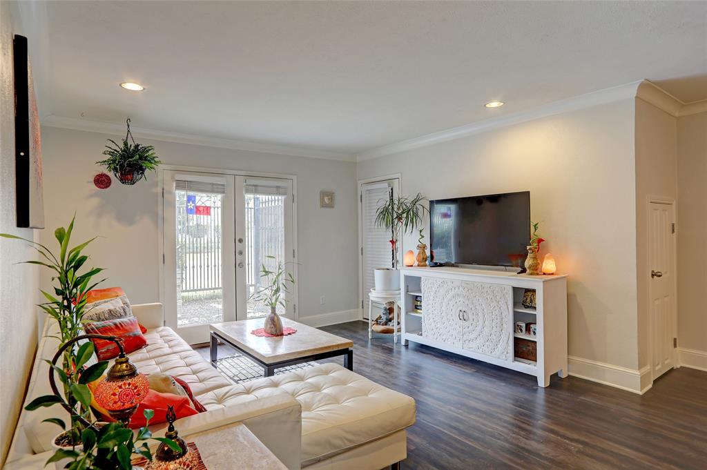 7736 Meadow Road, Unit 102 Dallas, TX 75230 - Photo 5 of 25 a living room with furniture and a flat screen tv
