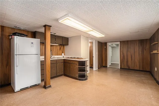 an empty room with a fireplace and windows