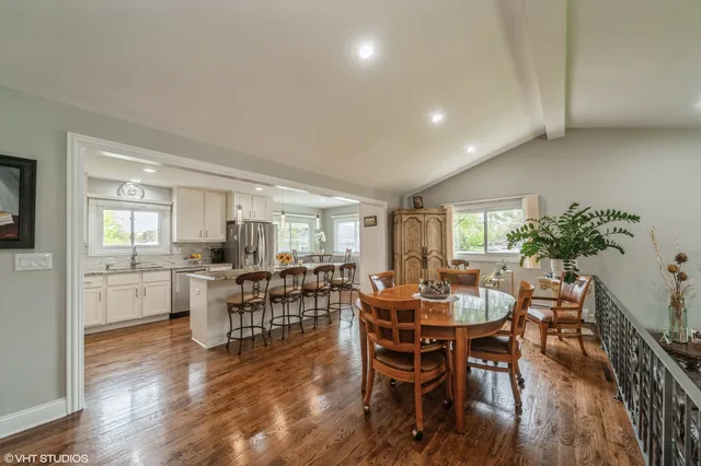 a view of a dining room with furniture and wooden floor