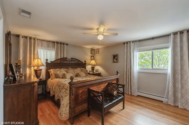 a bedroom with a bed and a chandelier
