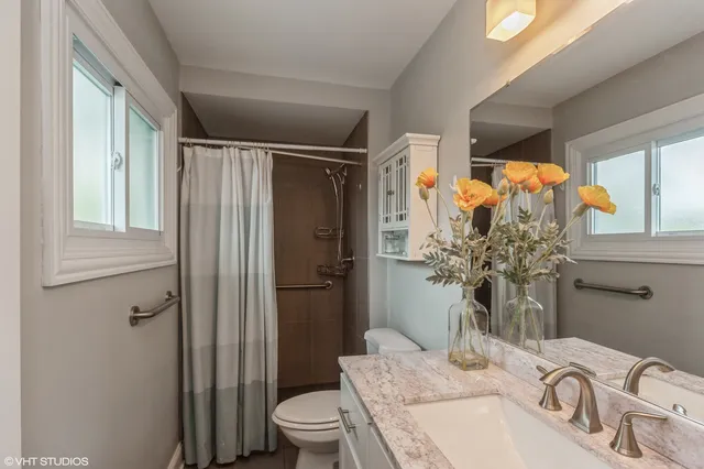 a bathroom with a sink toilet and shower