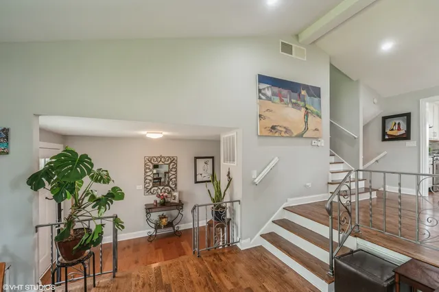 a living room with furniture floor to ceiling window and potted plant
