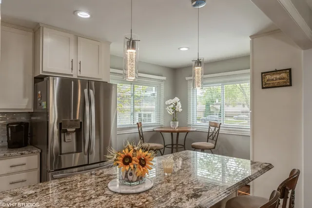 a dining room with furniture a window and kitchen view