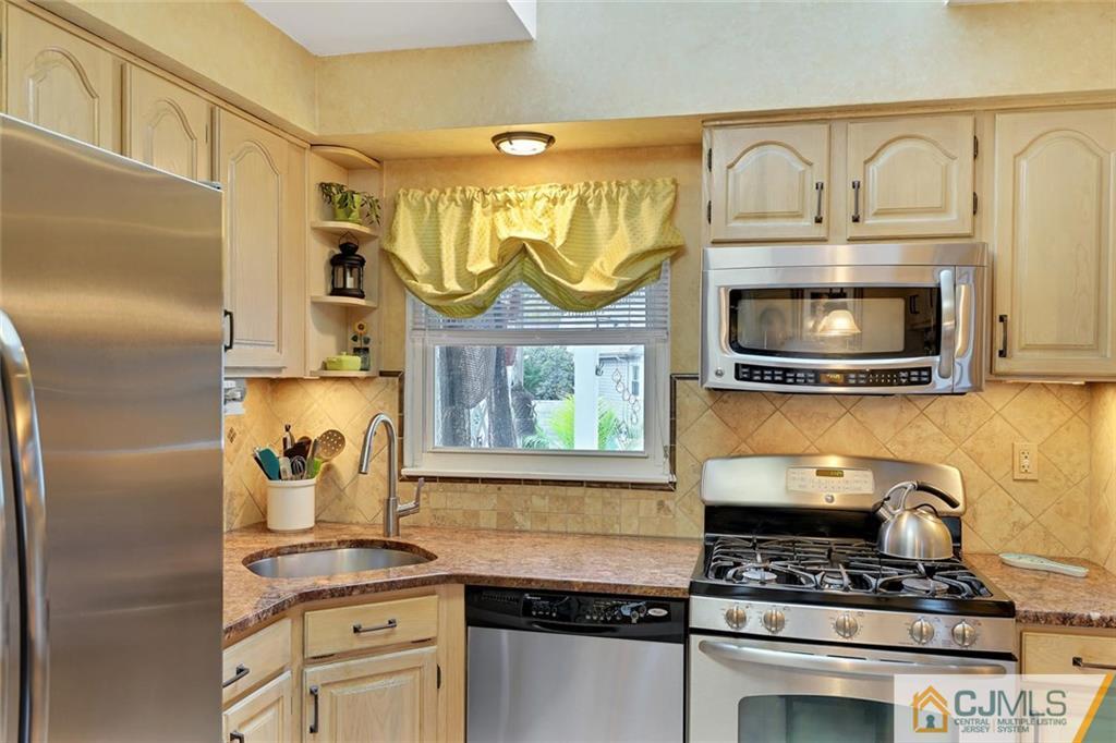 642 Inwood Road Linden, NJ 07036 - Photo 11 of 25 a kitchen with granite countertop a stove and a sink