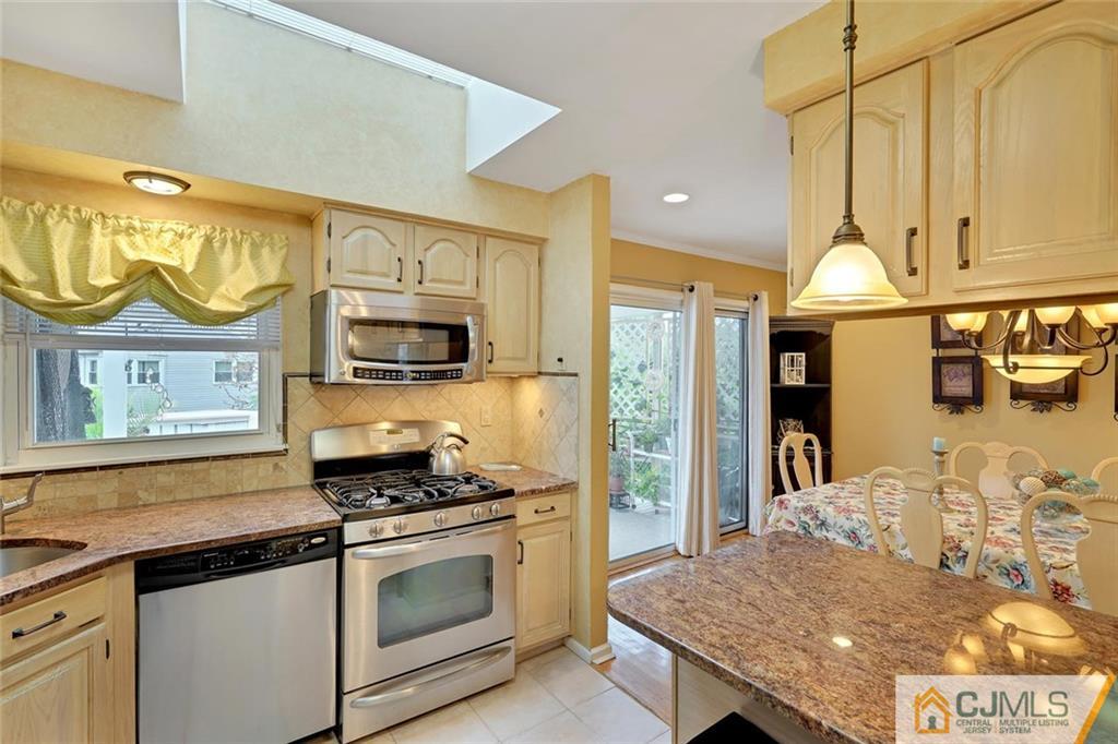 642 Inwood Road Linden, NJ 07036 - Photo 13 of 25 a kitchen with stainless steel appliances granite countertop a stove a sink and a microwave