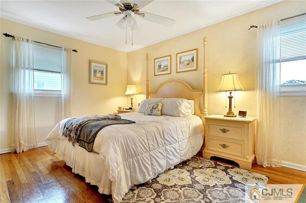 642 Inwood Road Linden, NJ 07036 - Photo 17 of 25 a bedroom with a bed and wooden floor