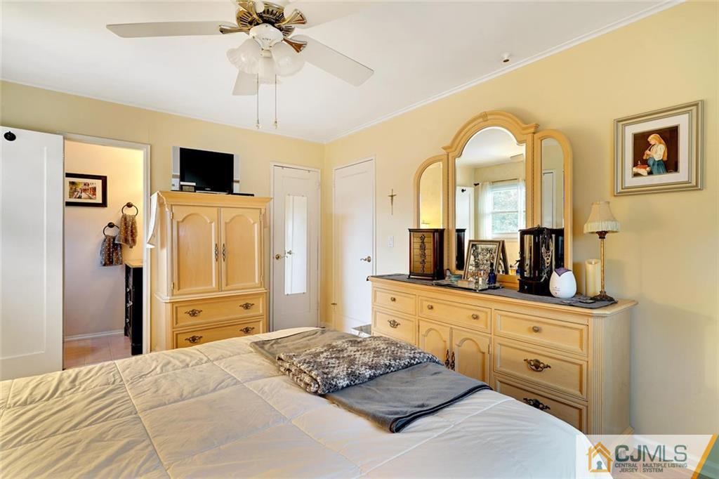 642 Inwood Road Linden, NJ 07036 - Photo 18 of 25 a bedroom with a bed and a flat screen tv