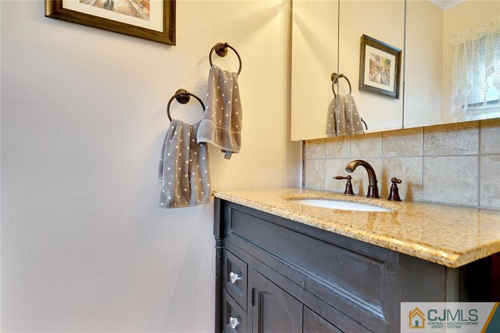 642 Inwood Road Linden, NJ 07036 - Photo 19 of 25 a bathroom with a sink and a mirror