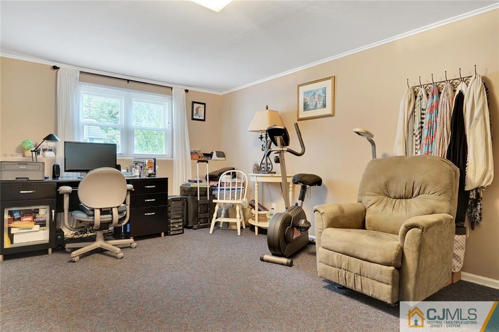642 Inwood Road Linden, NJ 07036 - Photo 21 of 25 a living room with furniture gym equipment and a large window