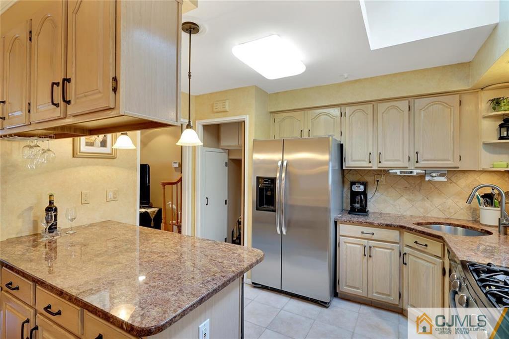 642 Inwood Road Linden, NJ 07036 - Photo 10 of 25 a kitchen with stainless steel appliances granite countertop a sink refrigerator and cabinets