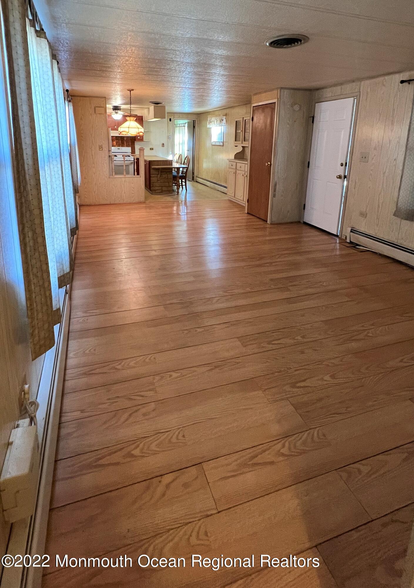705 Aviary Way Toms River, NJ 08755 - Photo 6 of 14 a view of an empty room with wooden floor