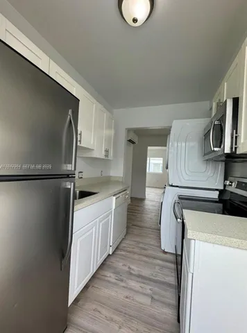 an empty room with wooden floor and a window