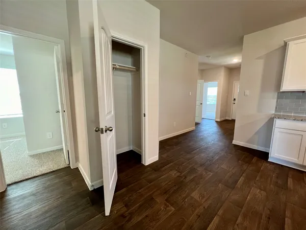a view of a hallway with wooden floor