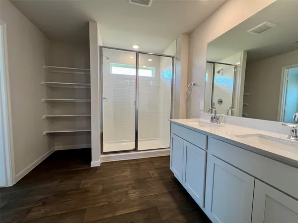 a bathroom with a double vanity sink and a mirror