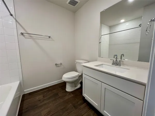 a bathroom with a sink toilet and vanity