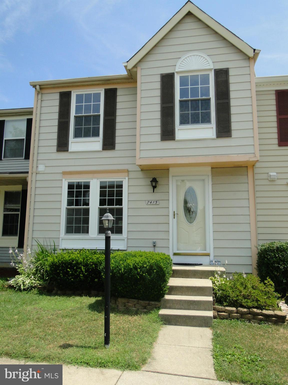 7415 Aspenpark Road Lorton, VA 22079 - Photo 1 of 17 a front view of a house with a yard and potted plants