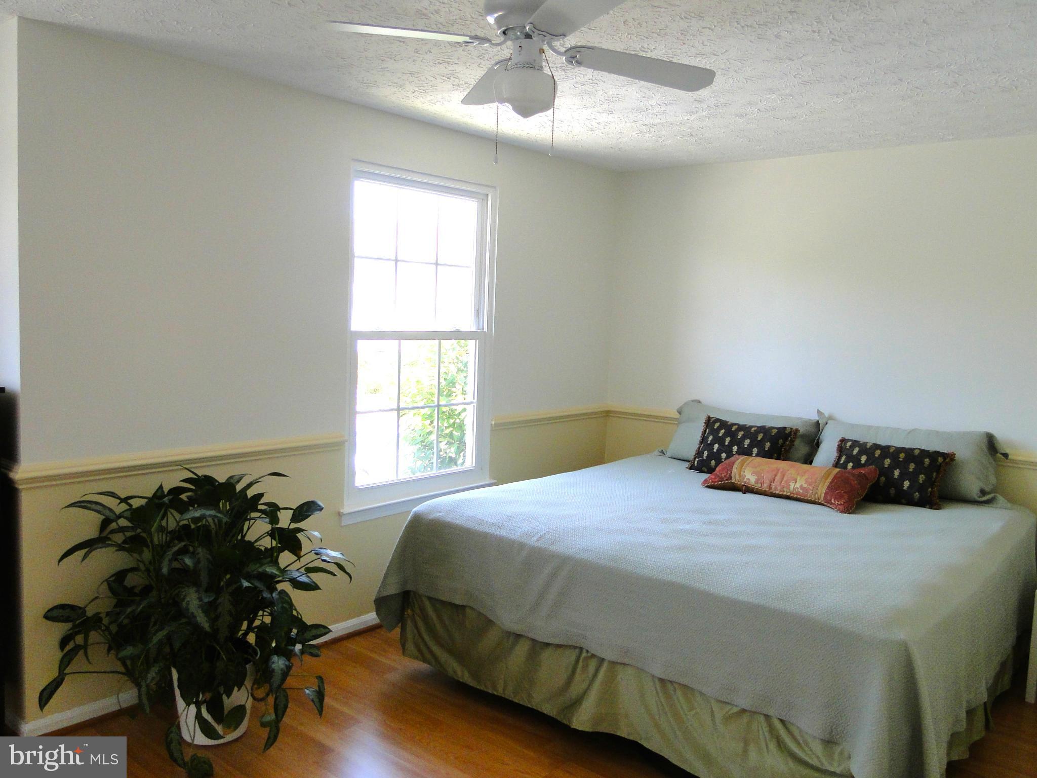 7415 Aspenpark Road Lorton, VA 22079 - Photo 11 of 17 a bedroom with a bed and a potted plant