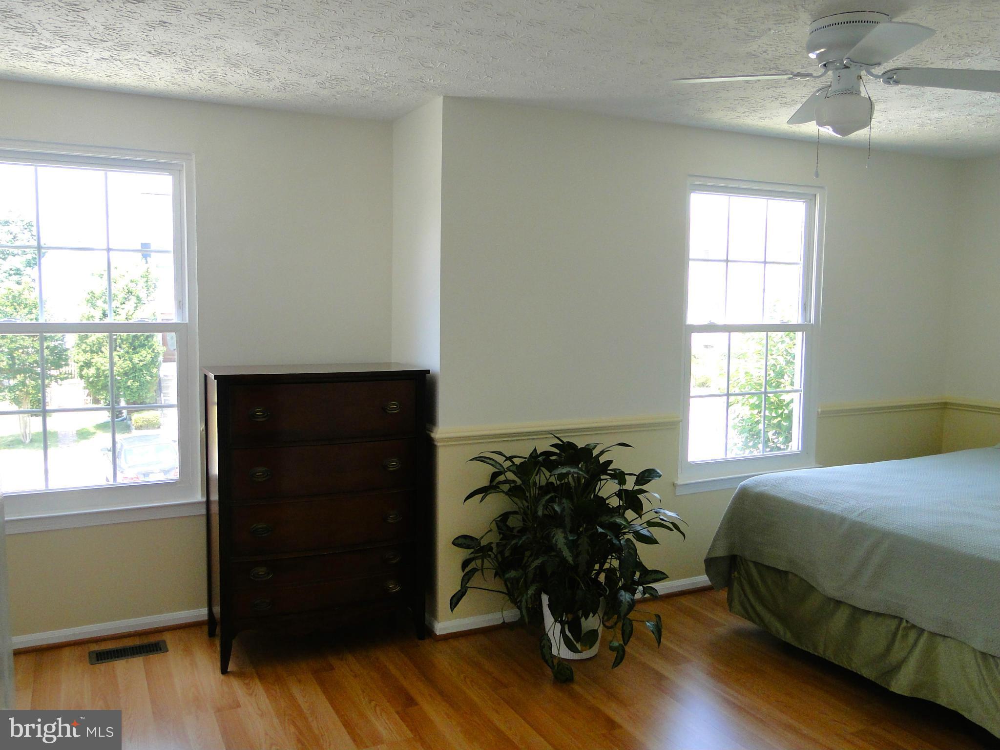 7415 Aspenpark Road Lorton, VA 22079 - Photo 12 of 17 a bed sitting in a bedroom next to a window
