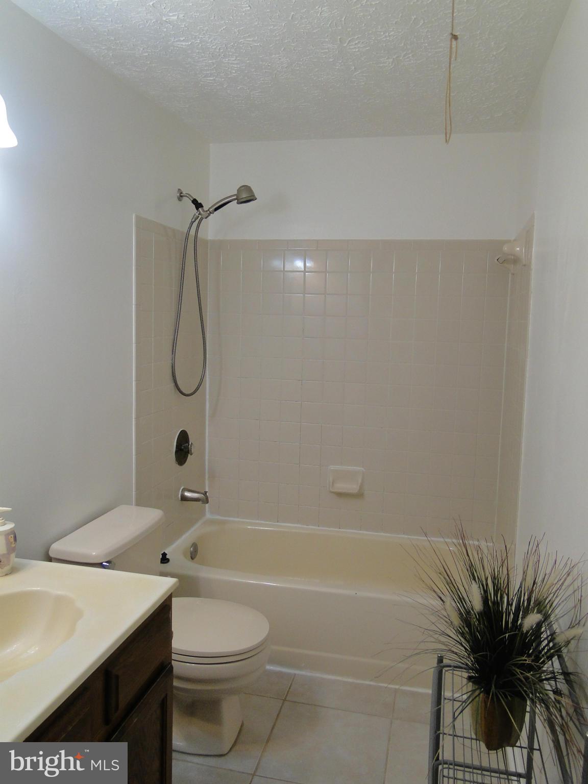 7415 Aspenpark Road Lorton, VA 22079 - Photo 13 of 17 a bathroom with a sink a toilet and shower
