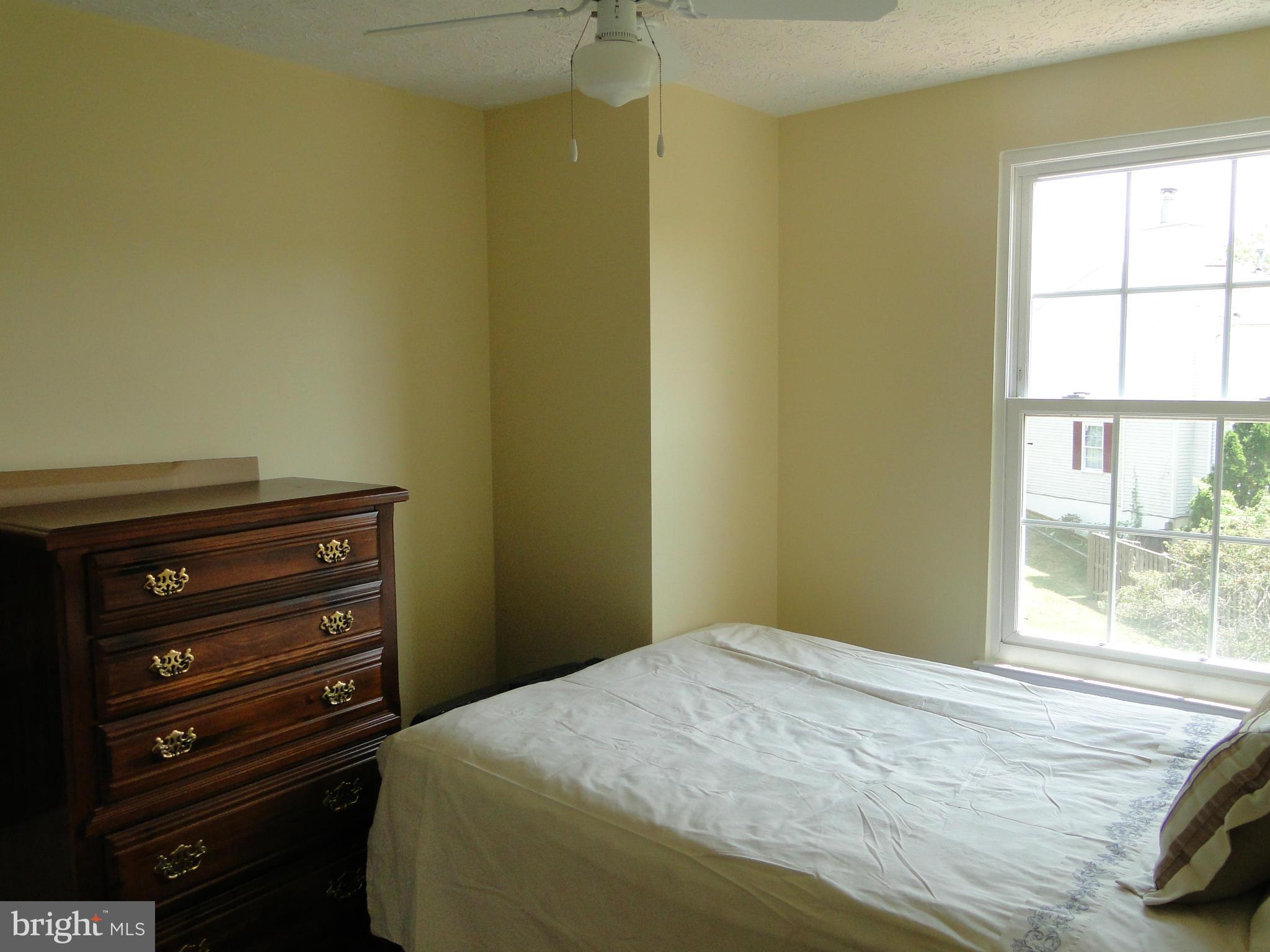 7415 Aspenpark Road Lorton, VA 22079 - Photo 14 of 17 a bedroom with a bed and a window