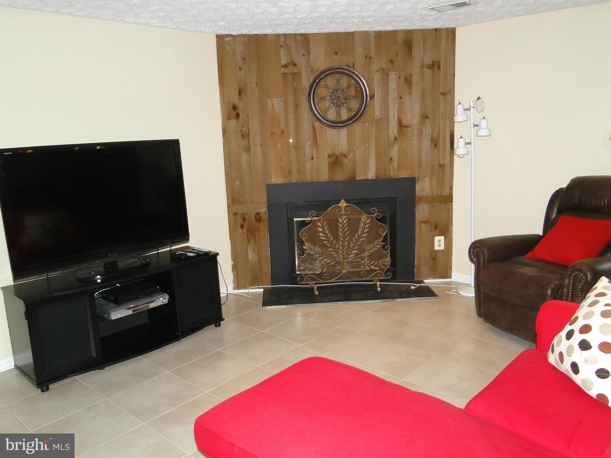 7415 Aspenpark Road Lorton, VA 22079 - Photo 16 of 17 a living room with furniture and a flat screen tv