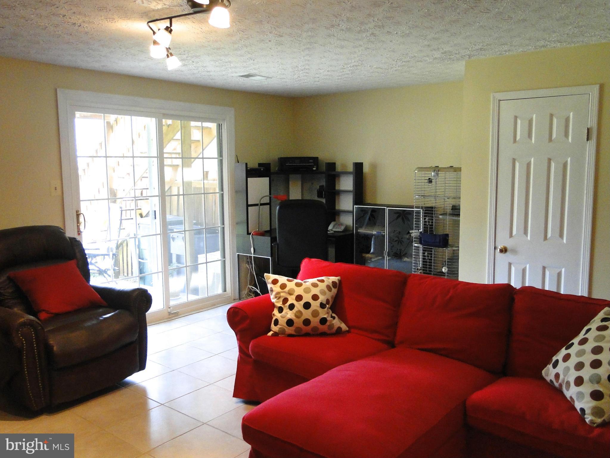 7415 Aspenpark Road Lorton, VA 22079 - Photo 17 of 17 a living room with furniture and a large window