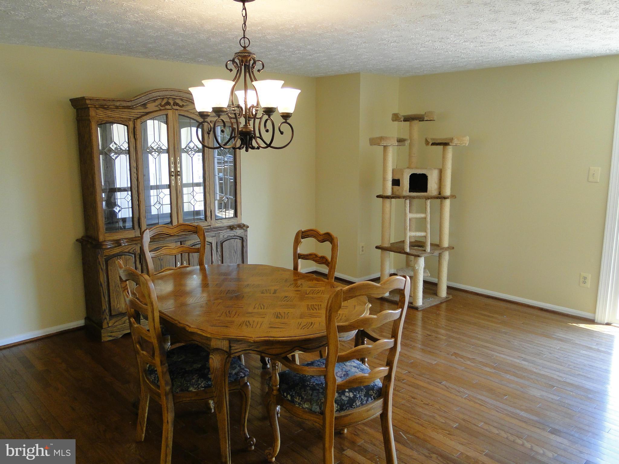 7415 Aspenpark Road Lorton, VA 22079 - Photo 8 of 17 a view of a dining room with furniture and wooden floor