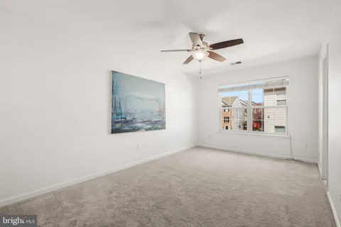 a view of a ceiling fan and hardwood floor