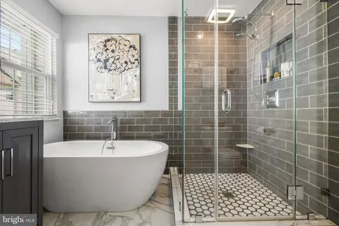 a bathroom with a bathtub and shower