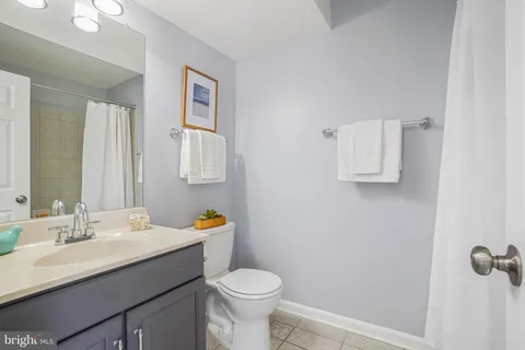 a bathroom with a sink toilet vanity and mirror