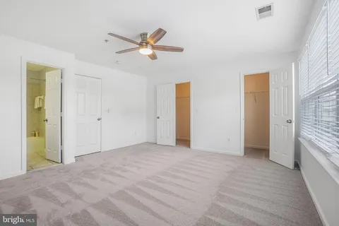 a view of a room with a ceiling fan