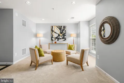 a living room with furniture and a chair