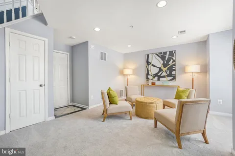 a living room with furniture and a rug