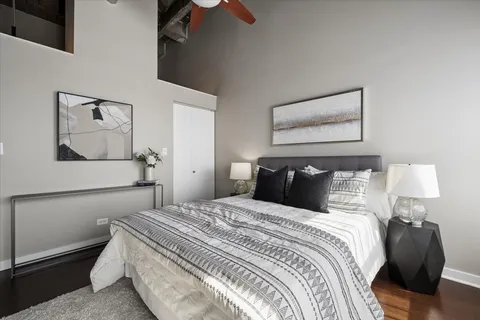 a bedroom with a bed and wooden floor