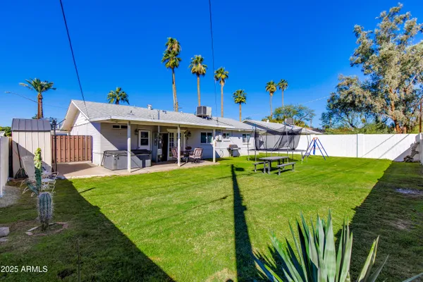 a view of an house with backyard space and sitting area