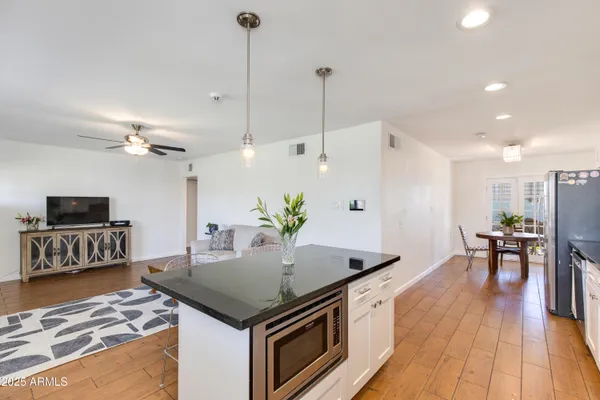 a kitchen with stainless steel appliances a stove a sink and a refrigerator