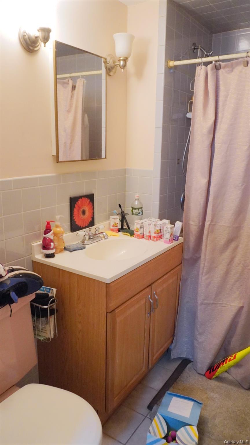 20 Pelhamside Drive New Rochelle, NY 10801 - Photo 16 of 28 a bathroom with a sink and a mirror