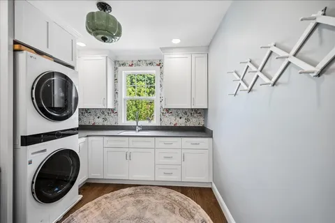 a utility room with sink dryer and washer