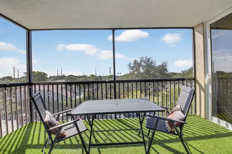 a view of a balcony with chairs